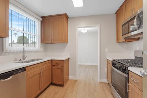 A kitchen with wooden cabinets and stainless steel appliances.