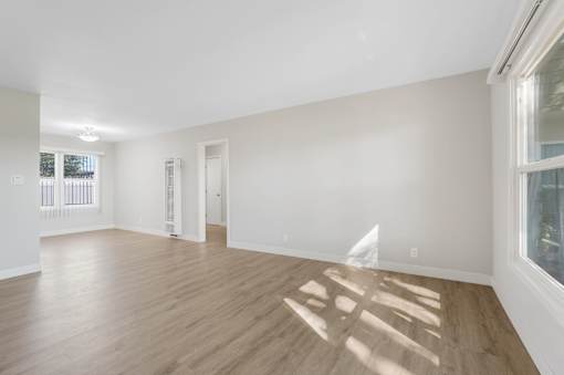 A room with wooden floors and white walls.