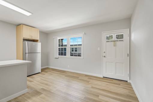 A kitchen with a refrigerator and a counter top.