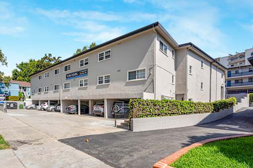 A building with a parking lot in front of it.