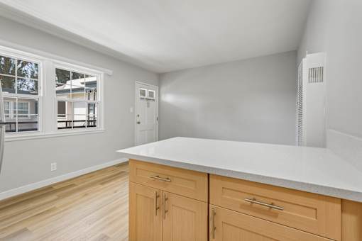 A kitchen with wooden cabinets and a white countertop.