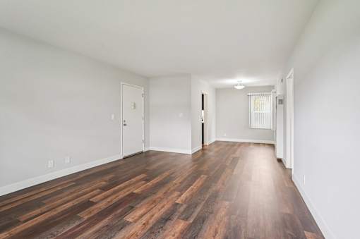 A room with wooden floors and white walls.