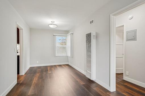 A room with wooden floors and white walls.