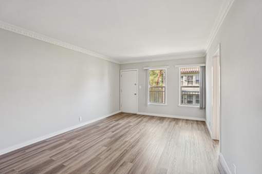 A room with a wooden floor and white walls.