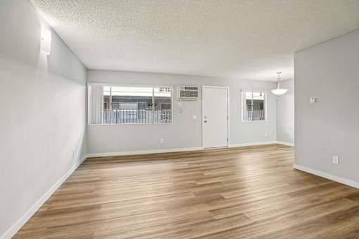 A room with wooden floors and white walls.