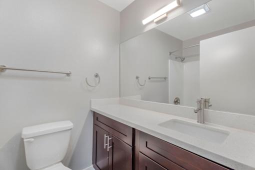 A white toilet sits next to a sink in a bathroom.