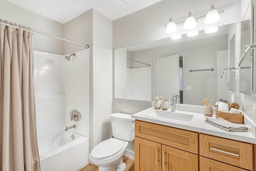A bathroom with a white toilet, a white sink, and a white bathtub.