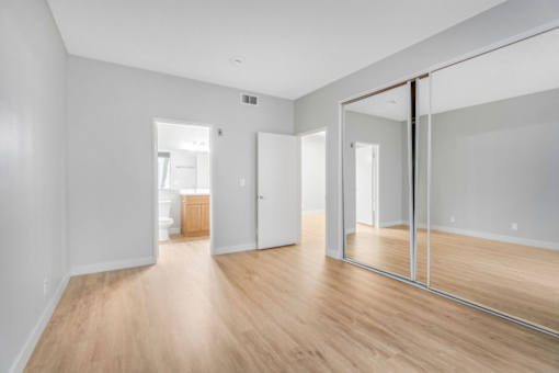 A room with wooden floors and white walls.