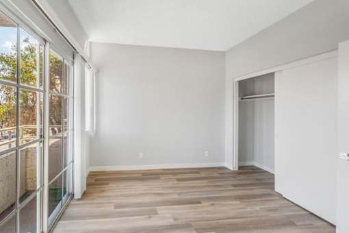 A room with a wooden floor and white walls.