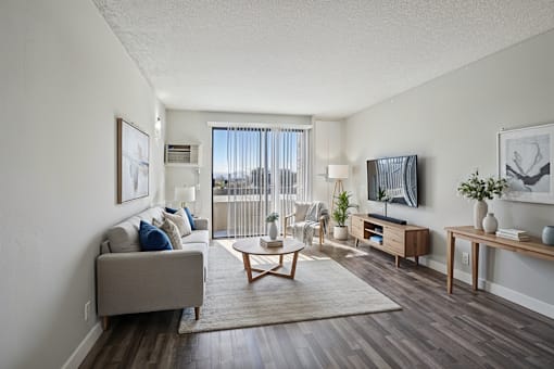 A living room with a grey couch and a coffee table.