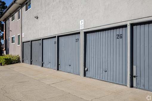 A parking sign is on the wall above the garage doors.