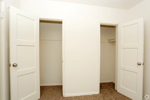 A white door is open to a hallway.