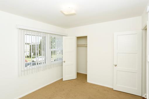 A white room with a window and a door.