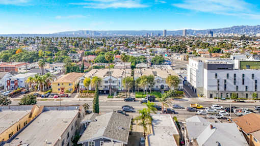 A cityscape with buildings and cars on the streets.