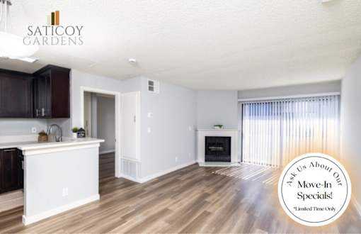 A kitchen with wooden floors and white walls, with a text overlay that says "Ask Us About Our Move-In Specials!".