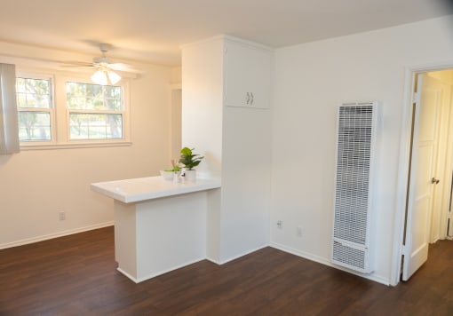 Arms kitchen. a kitchen with a white counter top and a window