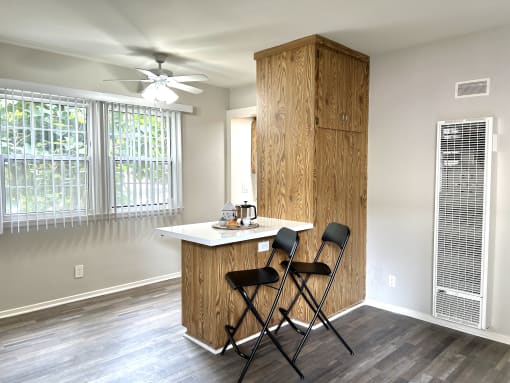 a kitchen with a island and two chairs