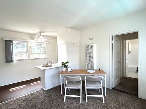 A white room with a table and chairs.