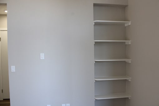 Empty shelves in a room with white walls.