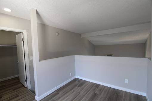 A room with white walls and wooden flooring.