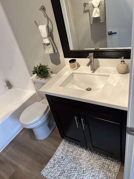 a bathroom with a toilet and a sink and a mirror