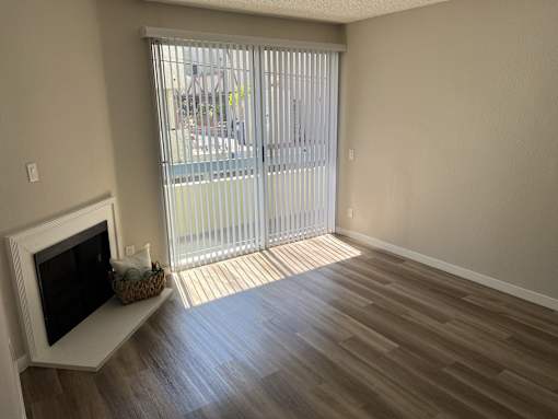 a living room with a fireplace and a sliding glass door