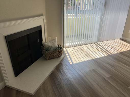 a living room with a fireplace and a sliding glass door