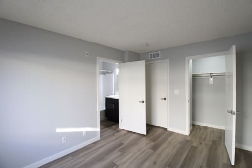 an empty living room with white walls and wood flooring