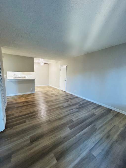 A room with a wooden floor and white walls.