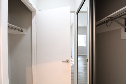 the door to the closet in the master bathroom is open