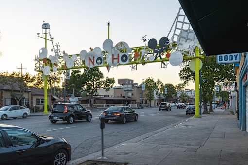 A street scene with cars and a sign that says "NO HO".