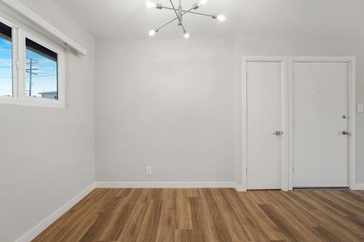A room with wooden floors and white walls.