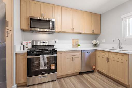 A kitchen with wooden cabinets and stainless steel appliances.