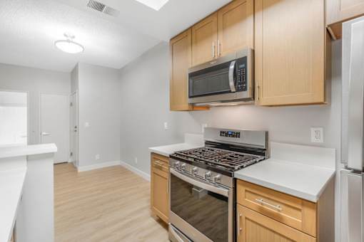 A kitchen with a stove top oven and microwave.