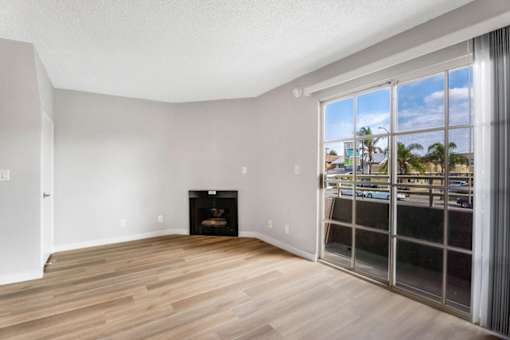 A room with a fireplace and a view of the outside.
