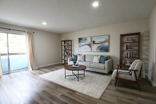 A living room with a couch, a chair, and a coffee table.