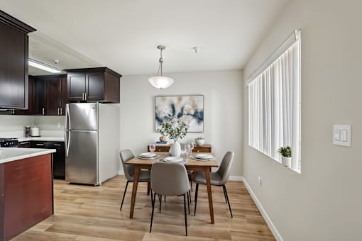 A kitchen with a dining table set for four.