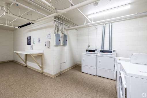 A laundry room with washers and dryers.