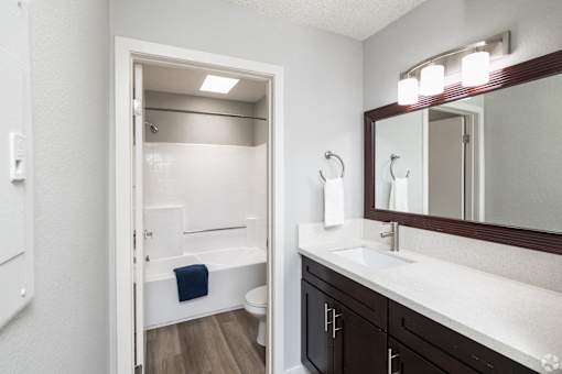 A bathroom with a white sink and a white toilet.