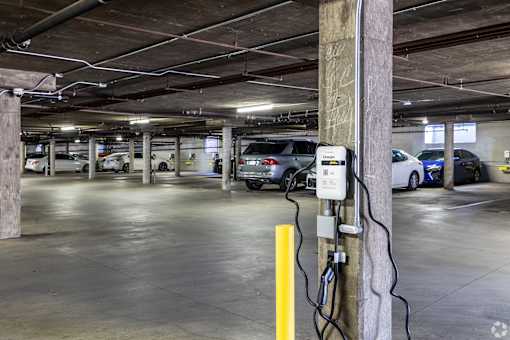 A parking garage with a charging station for electric vehicles.