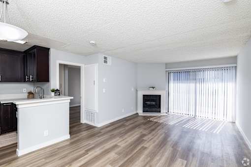 A modern kitchen with dark wood cabinets and a white island.