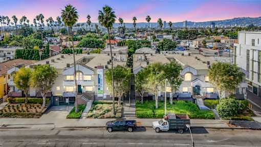 A residential area with houses and parked cars.