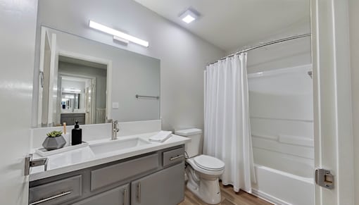 A bathroom with a white toilet and a white sink.