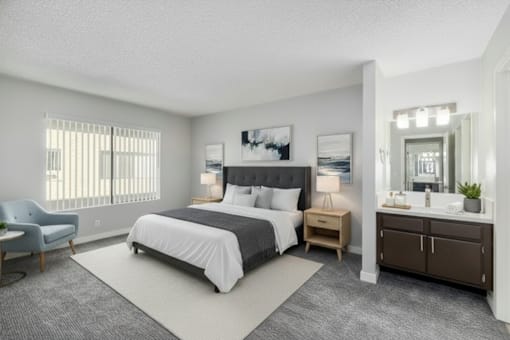 A bedroom with a large bed, a chair, and a dresser.