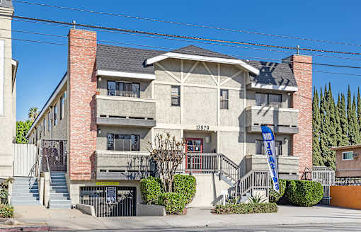 A house with a blue sign in front of it.