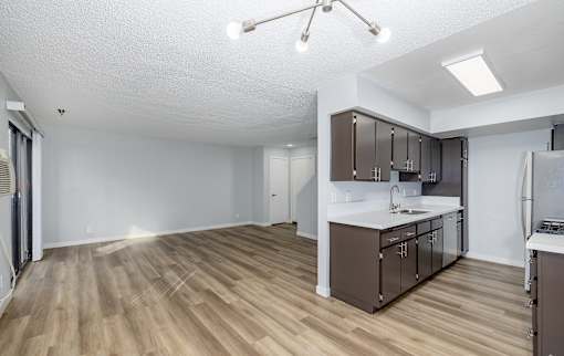 A kitchen with brown cabinets and a white countertop.