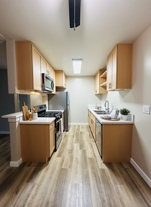 A kitchen with wooden cabinets and a white counter.