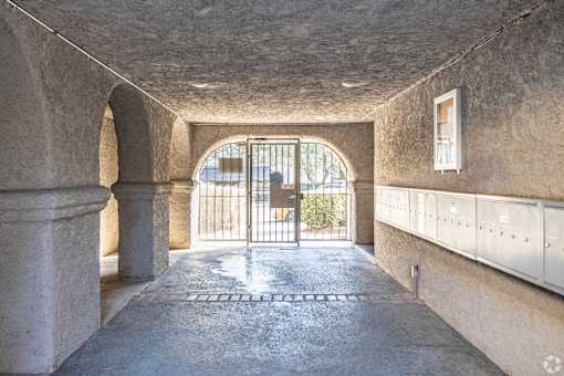 A tunnel with a metal gate at the end.