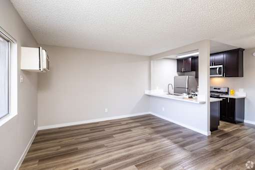 A kitchen area with a refrigerator, microwave, and oven.