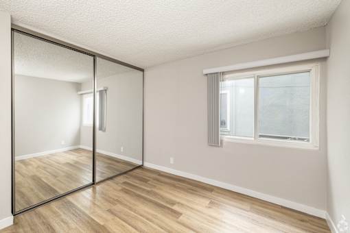 A room with a sliding glass door and a window.